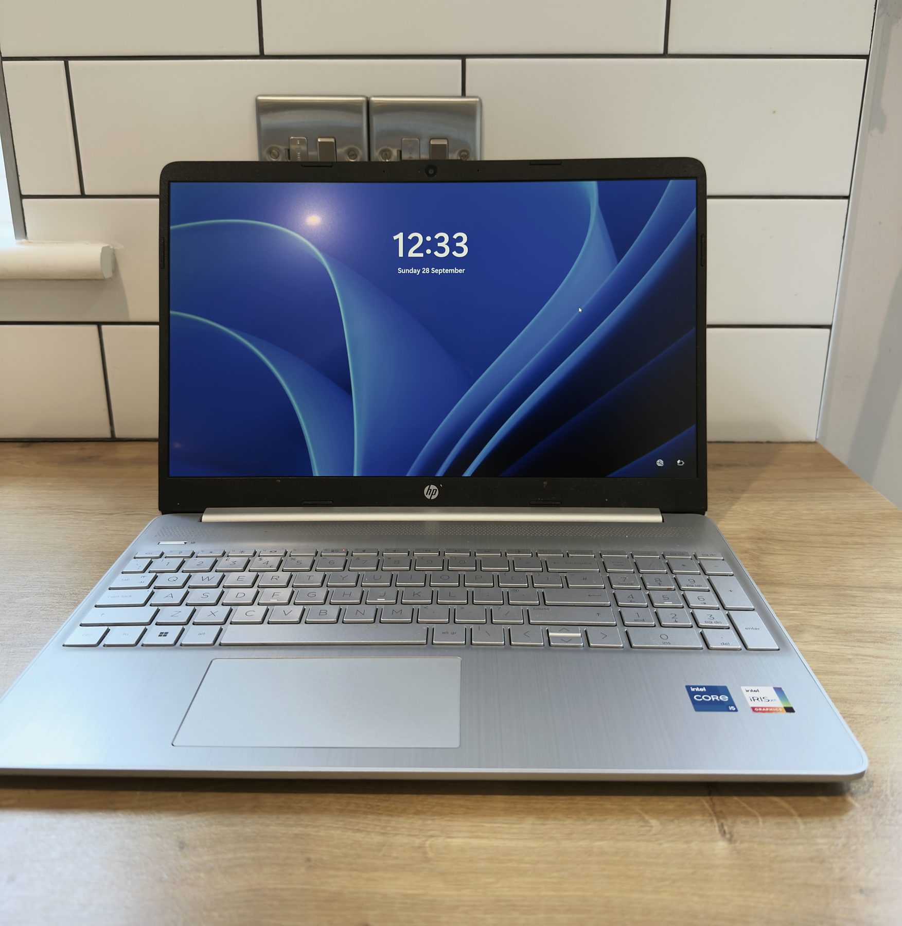 A laptop set up and showing the lock screen