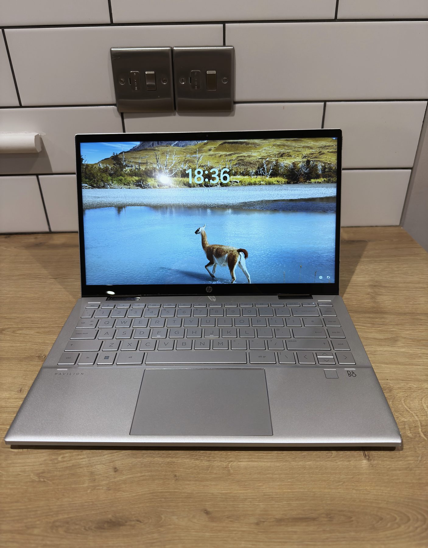 An HP laptop set up and ready on a worktop