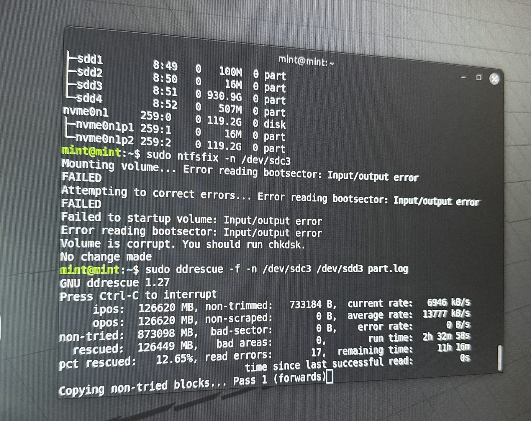A terminal showing ddrescue recovering files from a failing drive